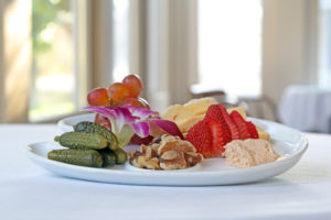 appetizer plate with fruits nuts and pickles