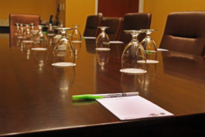 Courtyard Marriott conference table with glasses pens and pads