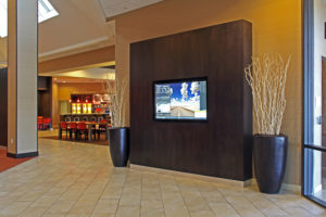 television in hotel lounge with cafe in background