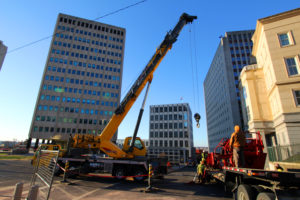 crane in downtown city with skyscrapers