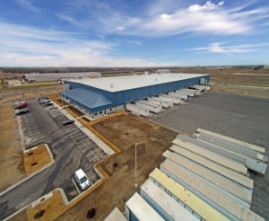 crane shot of commercial building 18 wheeler loading dock