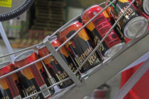 BJs red ale beer cans on assembly line
