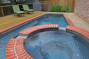 backyard pool with hot tub