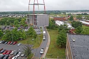 HVAC equipment suspended in air by crane