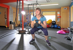 woman working out with kettle ball