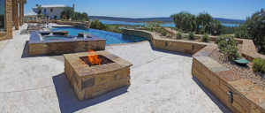 backyard pool with hot tub and fire pit overlooking lake