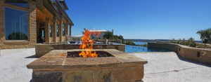 fire pit closeup with pool and hot tub in background