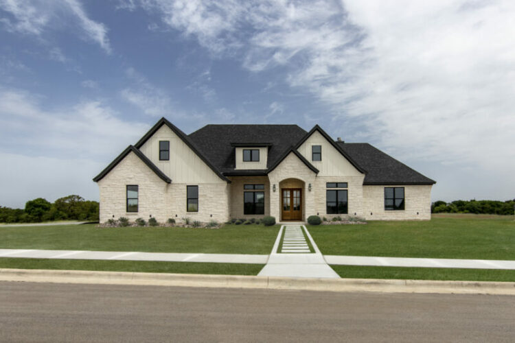 exterior of home with white brick and black trim