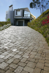 paved stone driveway leading to two-story house