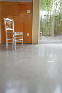 stained concrete floor with white chair