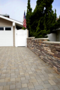 stonework wall and paved stone drive in driveway