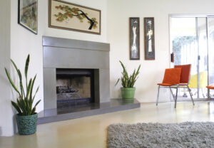 living room with stained concrete fireplace